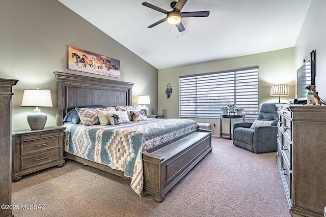 carpeted bedroom with ceiling fan and vaulted ceiling