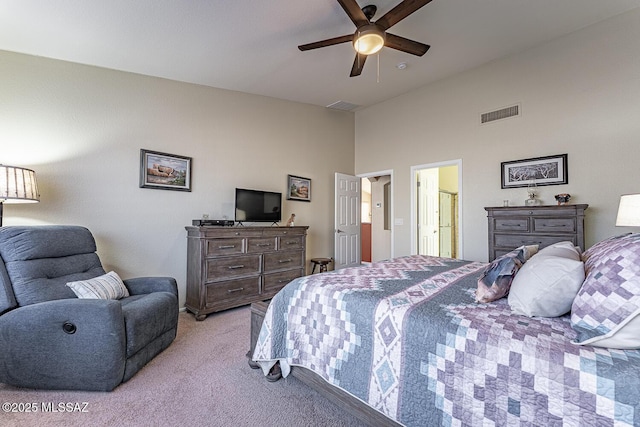 bedroom with light carpet, ceiling fan, and a high ceiling