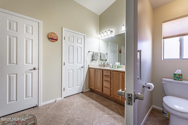 bathroom featuring tile patterned flooring, vanity, and toilet