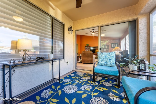 sunroom featuring ceiling fan