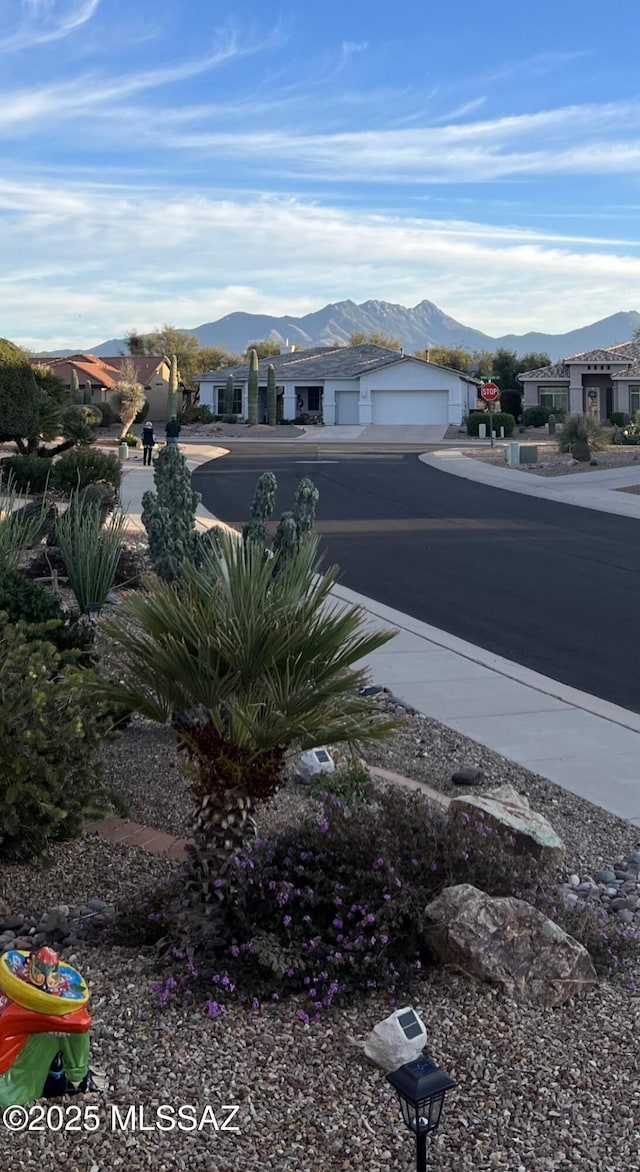 view of yard with a mountain view and a garage