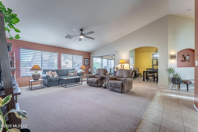 living room with high vaulted ceiling, light colored carpet, and ceiling fan