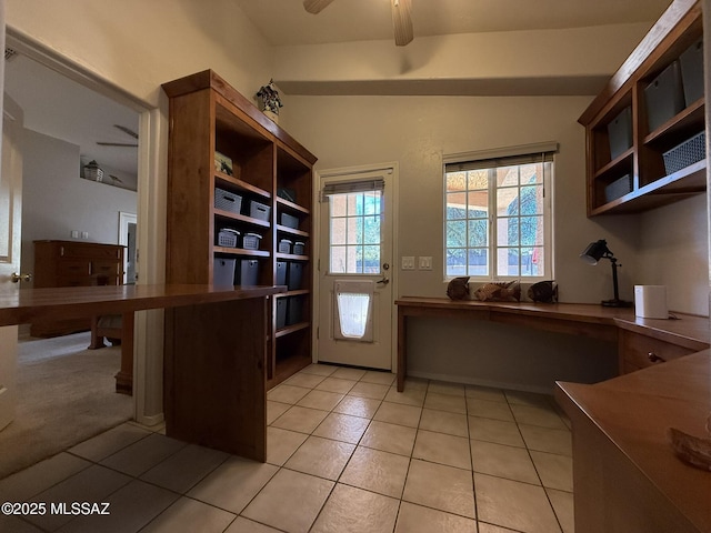 unfurnished office featuring ceiling fan and light tile patterned floors