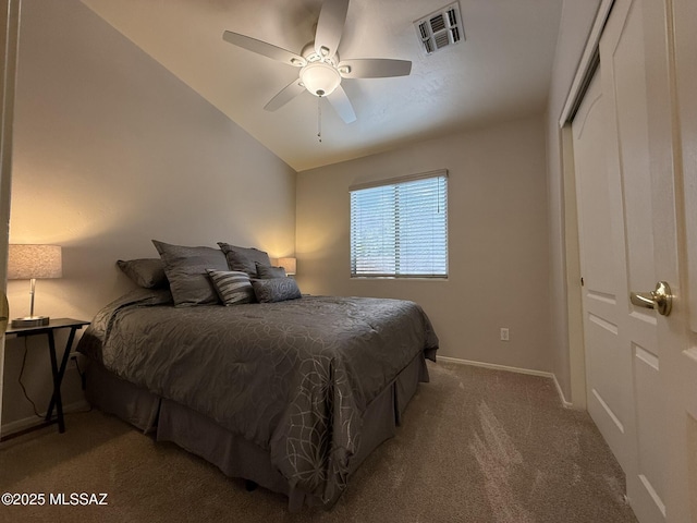 bedroom featuring carpet, a closet, vaulted ceiling, and ceiling fan