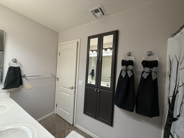 bathroom with tile patterned floors and vanity