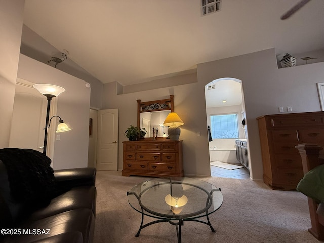 carpeted living room featuring lofted ceiling