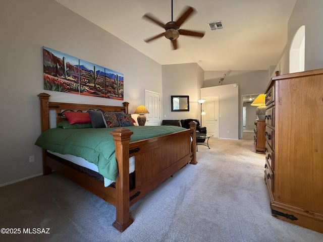 bedroom featuring ceiling fan, light colored carpet, and vaulted ceiling