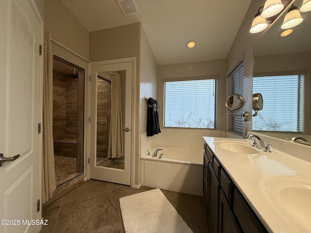 bathroom featuring tile patterned floors, vanity, and shower with separate bathtub