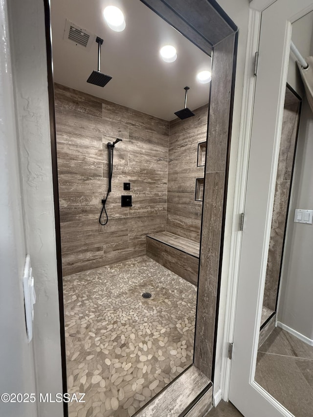 bathroom with a tile shower