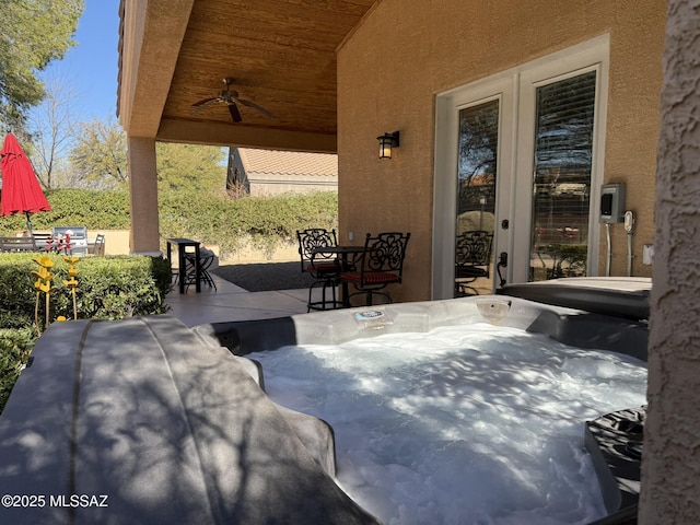 view of patio featuring a hot tub and ceiling fan