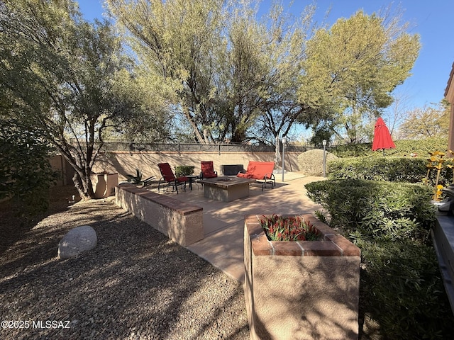 view of yard with a fire pit and a patio