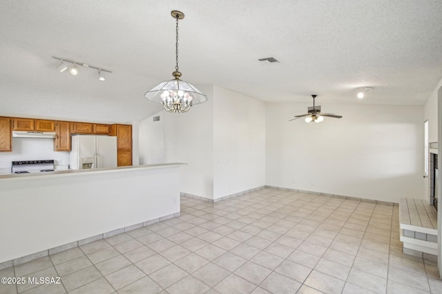 unfurnished living room featuring vaulted ceiling, ceiling fan with notable chandelier, a textured ceiling, and light tile patterned floors