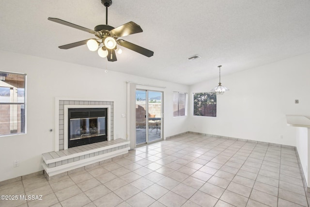 unfurnished living room with light tile patterned floors, a textured ceiling, and ceiling fan