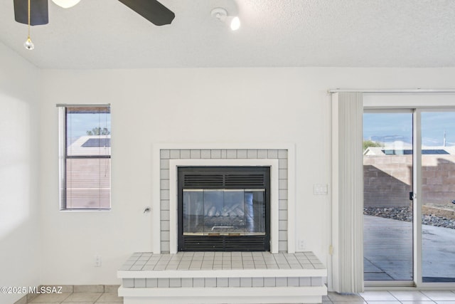 details with ceiling fan, a brick fireplace, and a textured ceiling