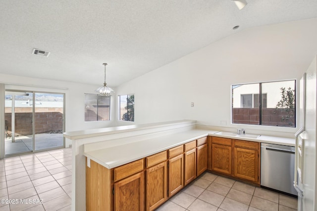 kitchen featuring vaulted ceiling, light tile patterned floors, stainless steel dishwasher, kitchen peninsula, and pendant lighting