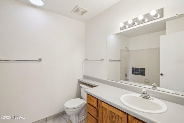 bathroom with vanity, toilet, tile patterned flooring, and a shower