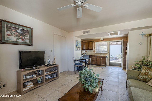 living room with visible vents, ceiling fan, and light tile patterned floors