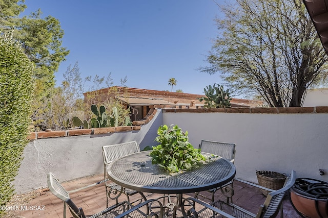 view of patio / terrace featuring a balcony and outdoor dining space