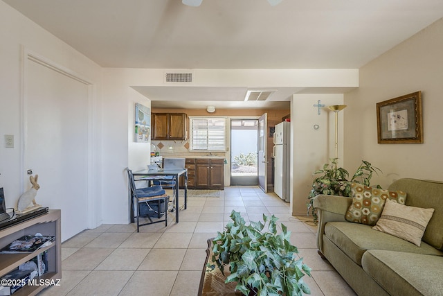 living room featuring visible vents and light tile patterned floors