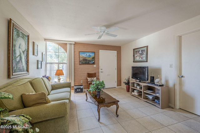 living room with a ceiling fan and light tile patterned floors