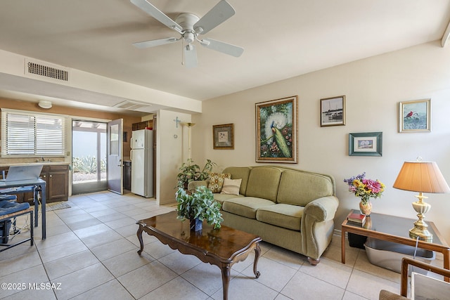 living room featuring visible vents, ceiling fan, and light tile patterned flooring