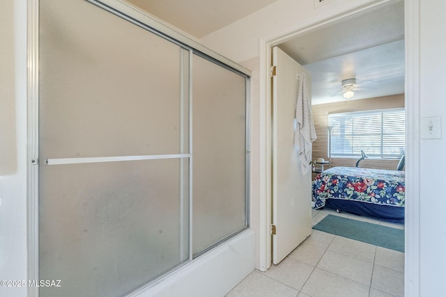 bathroom with a ceiling fan, tile patterned flooring, enclosed tub / shower combo, and ensuite bath