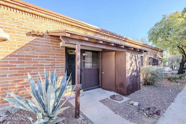 property entrance with brick siding