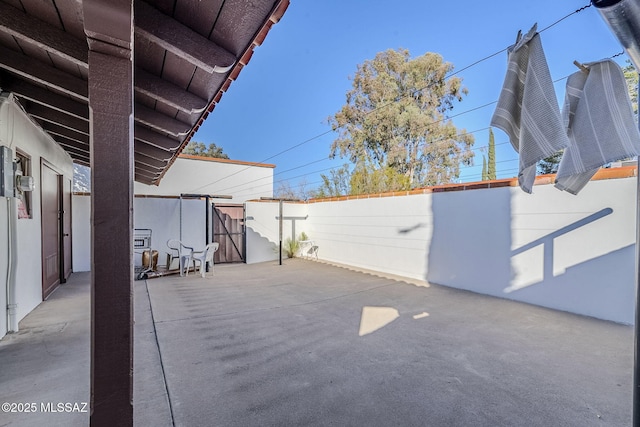 view of patio featuring fence