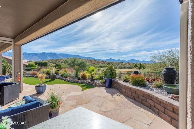 view of patio / terrace featuring an outdoor living space, a fenced backyard, and a mountain view