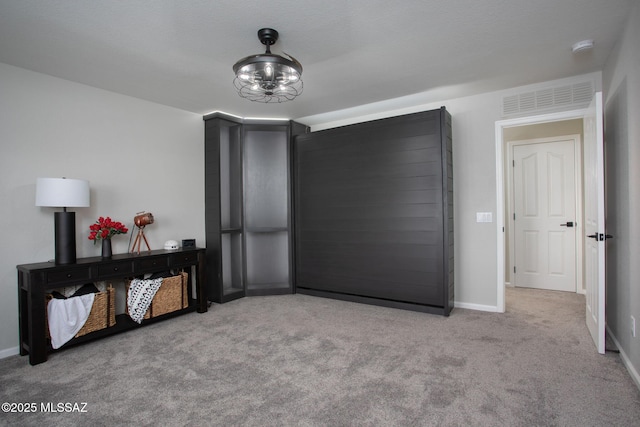 bedroom featuring baseboards, visible vents, and light colored carpet