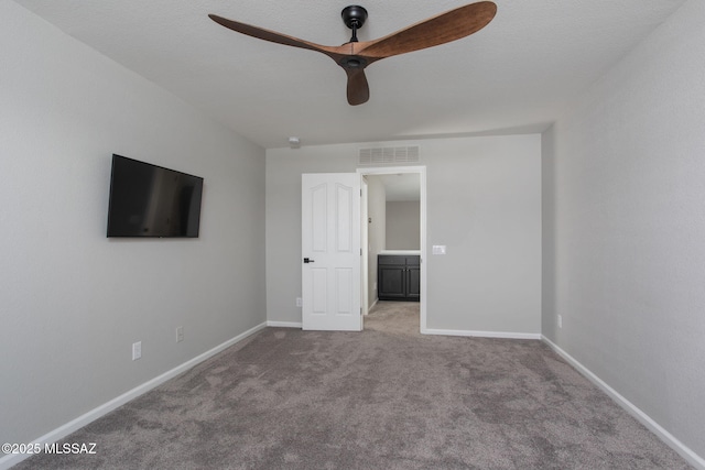 unfurnished bedroom featuring carpet floors, visible vents, ceiling fan, and baseboards