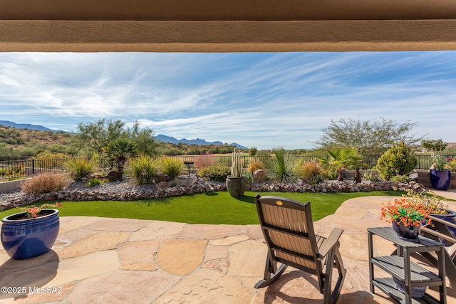 view of patio / terrace featuring a fenced backyard and a mountain view