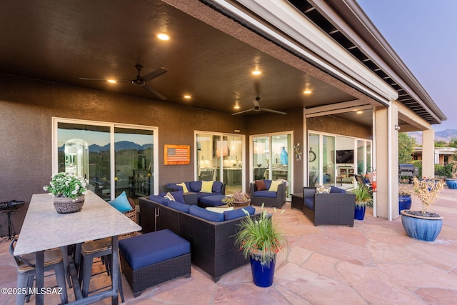 view of patio / terrace featuring outdoor dining area, ceiling fan, and outdoor lounge area