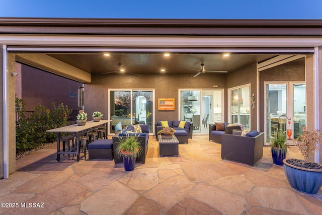 view of patio featuring a ceiling fan, outdoor dining space, and an outdoor hangout area