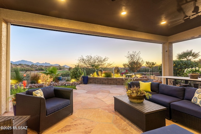 view of patio / terrace featuring a fenced backyard, a mountain view, and an outdoor hangout area