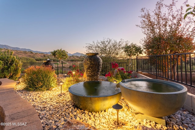 exterior space featuring a mountain view and fence