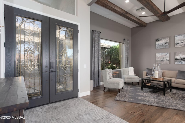 foyer featuring baseboards, visible vents, wood finished floors, french doors, and beam ceiling