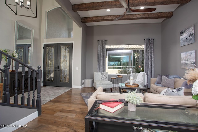 living area with dark wood-style flooring, baseboards, stairs, french doors, and beam ceiling