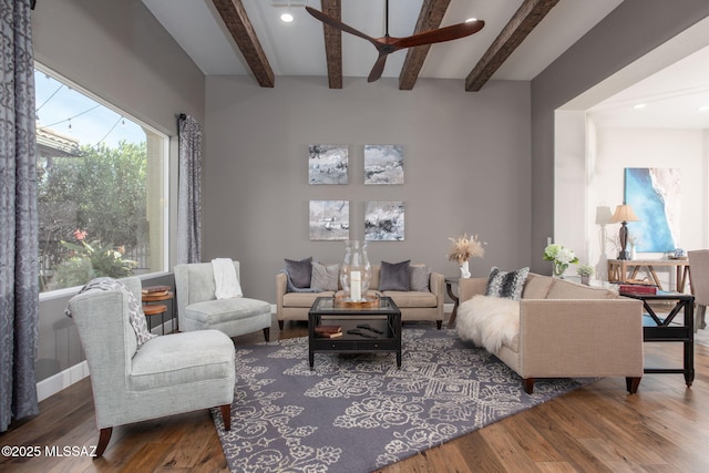 living room with visible vents, beamed ceiling, dark wood-style flooring, and a ceiling fan