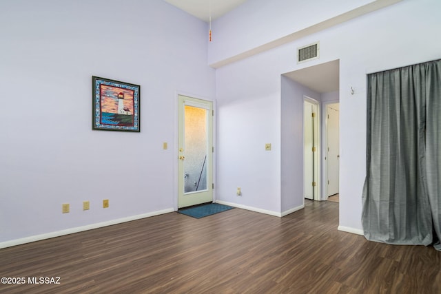 unfurnished room featuring dark wood-type flooring