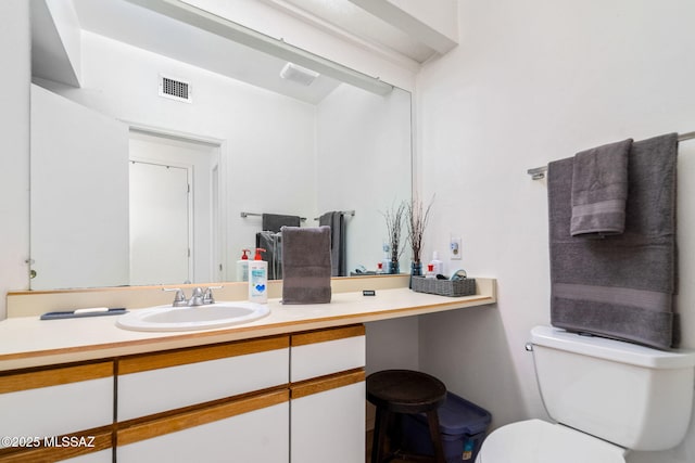 bathroom featuring toilet and vanity