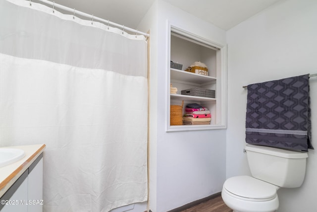 bathroom with vanity, toilet, and hardwood / wood-style floors