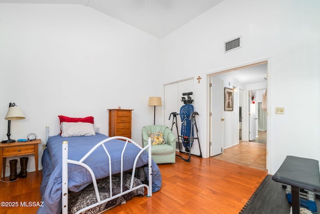 bedroom with hardwood / wood-style flooring and vaulted ceiling