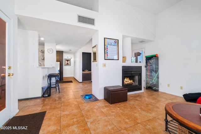 tiled living room with a high ceiling