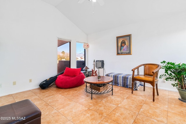 sitting room with ceiling fan, high vaulted ceiling, and light tile patterned flooring