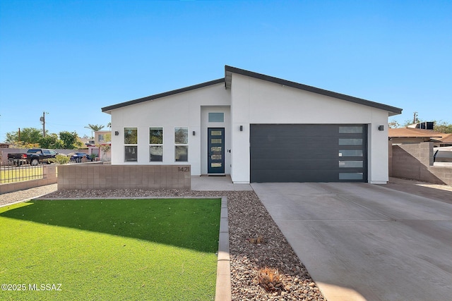 contemporary house featuring a garage and a front yard