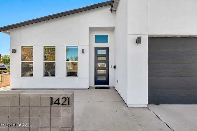 doorway to property with a garage