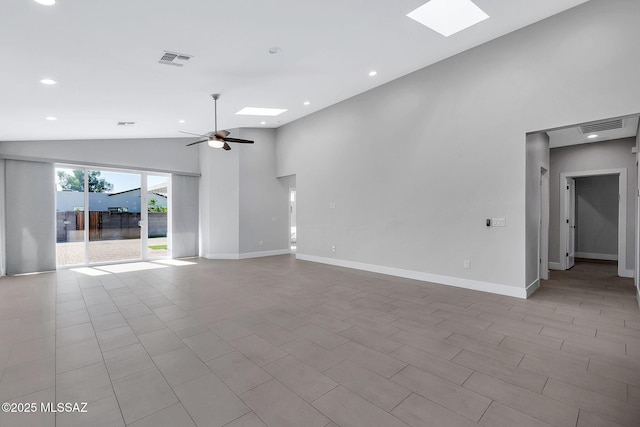 unfurnished living room with lofted ceiling with skylight and ceiling fan