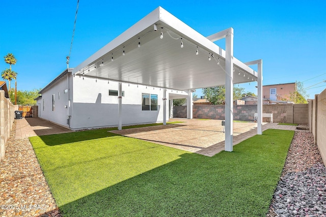 back of house featuring a yard and a patio area