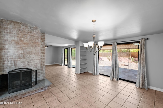 unfurnished dining area with a fireplace, ceiling fan with notable chandelier, light tile patterned floors, and lofted ceiling